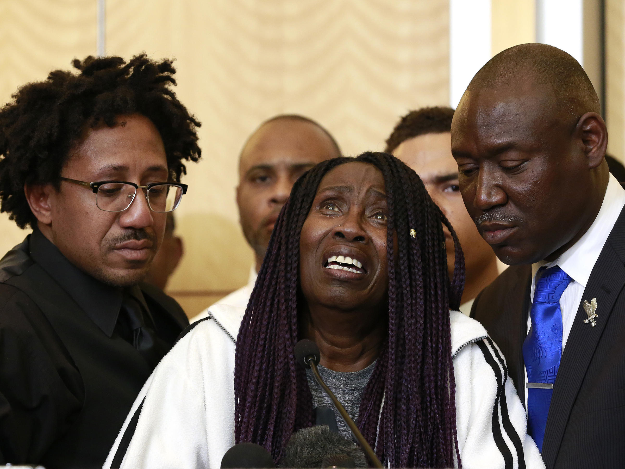 Sequita Thompson pleads for the officers who killed her grandson, Stephon Clark, to face criminal charges. Clark's uncle Kurtis Gordon stands on the left and Attorney Ben Crump on the right.
